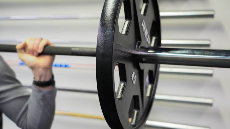 Rep Fitness Equalizer Iron Plate on a barbell