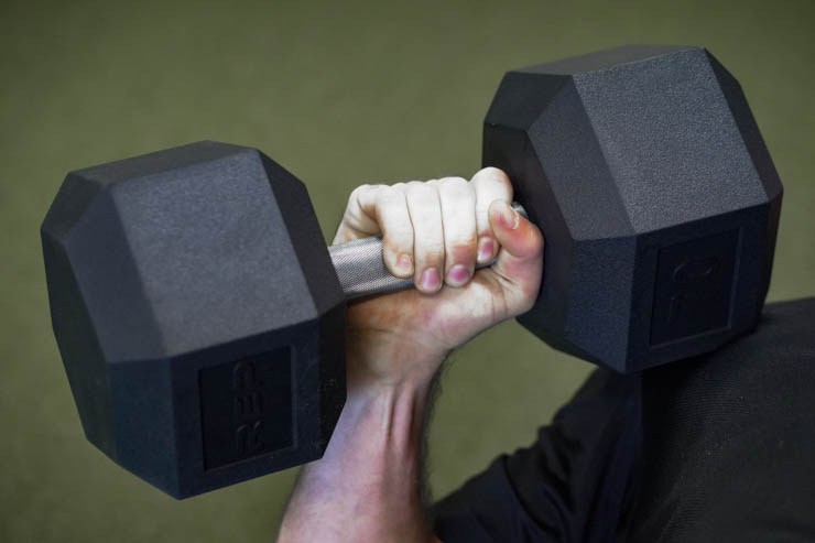 Someone holding a very heavy dumbbell.
