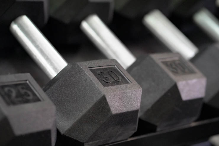 25- and 30- pound dumbbells laying next to each other. 