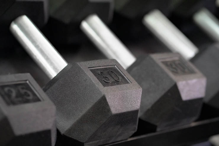 25- and 30- pound dumbbells laying next to each other.