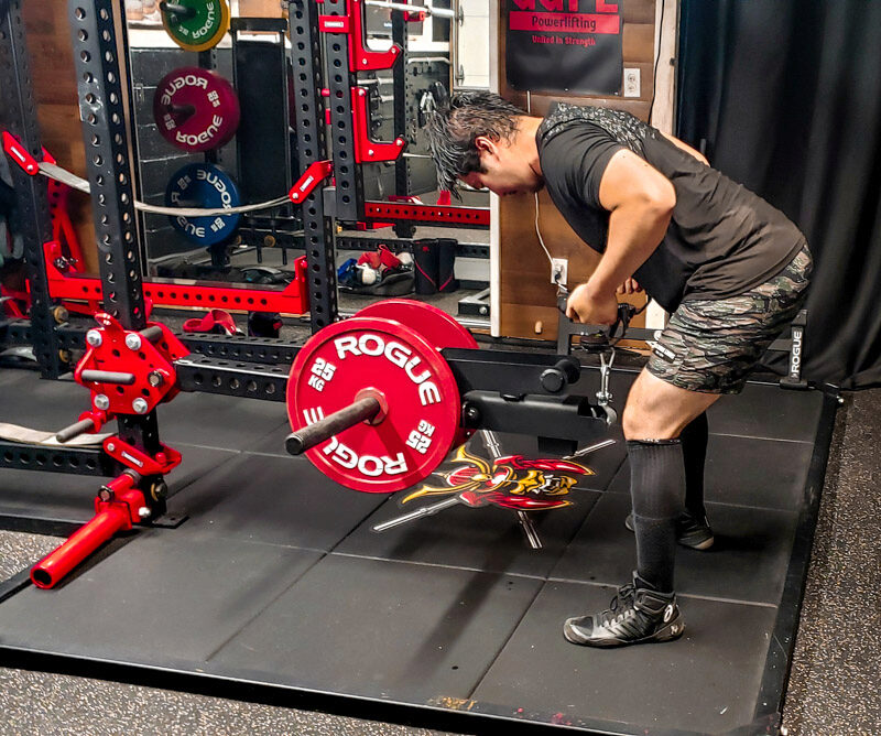 man performing a back exercise with the Sorinex J*Squat Belt Squat