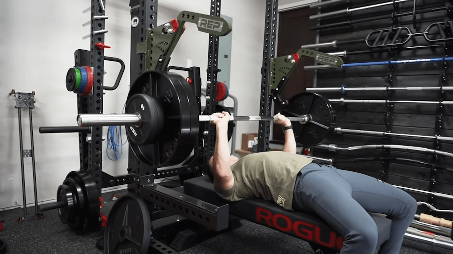 coop performing a bench press with the REP Fitness Monolift Attachment arms