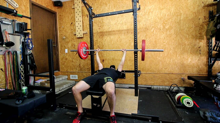 man doing a bench press on the PRx Performance Profile Squat Rack and bench
