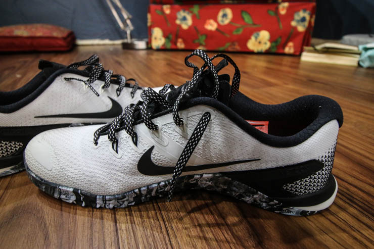 white and black Nike Metcon 4