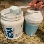 Scoop of 1st Phorm BCAAs going into a cup