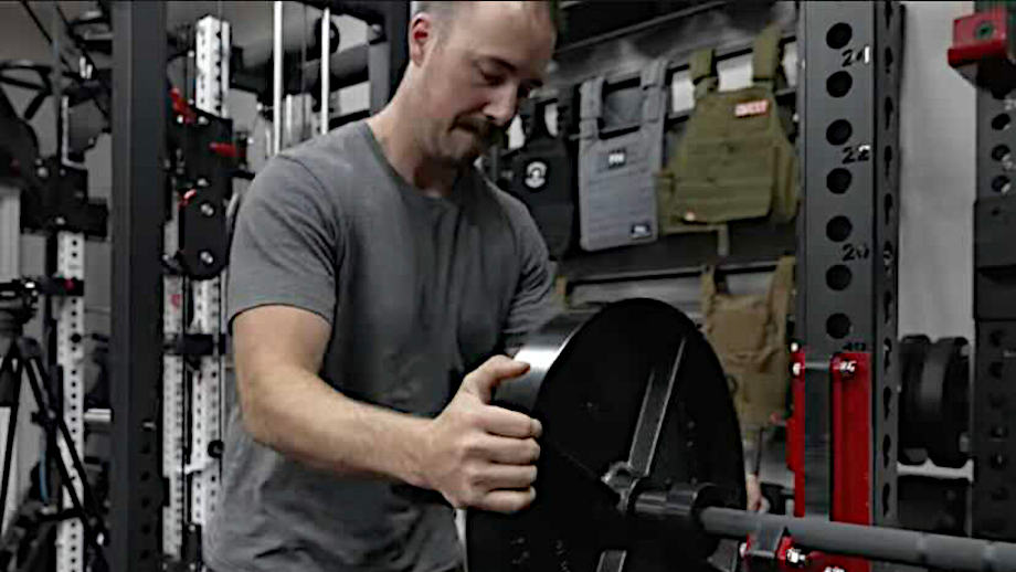 Coop puts a weight plate on the Rogue Ohio Barbell