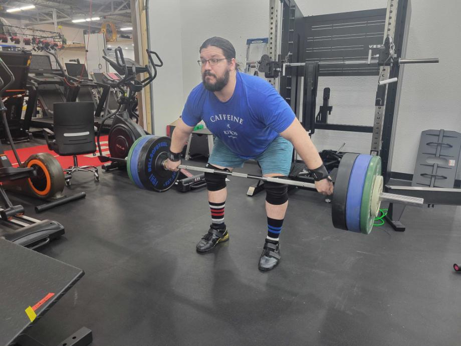 Man performing a snatch pull using the Eleiko IWF Weightlifting Competition Bar