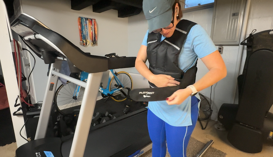 Nicole Davis puts on the LifePro FlexVest weighted vest in her garage gym.
