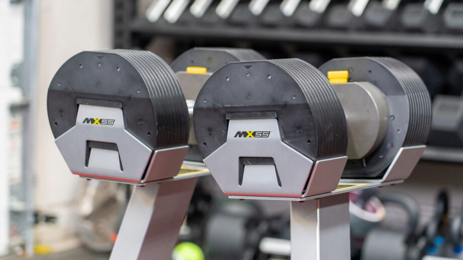 MX Select Adjustable dumbbells sitting in their respective stands.