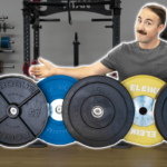 Coop standing behind several varieties of weight plates