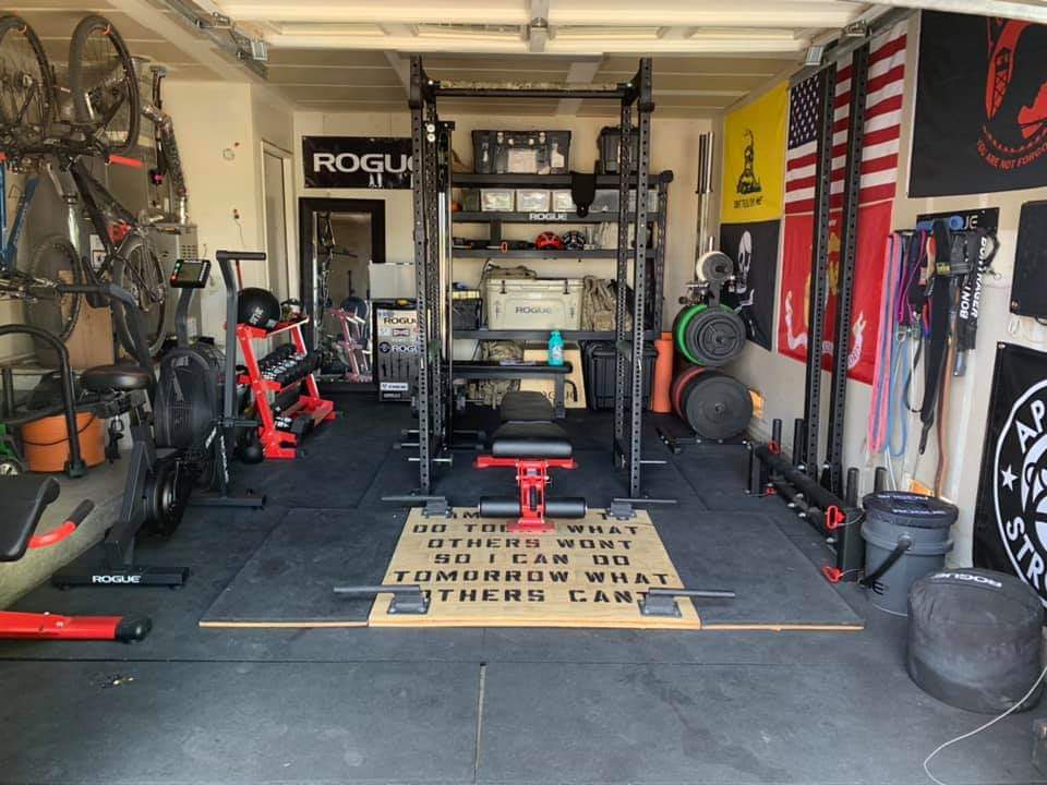 a full garage gym set-up with power rack and weight