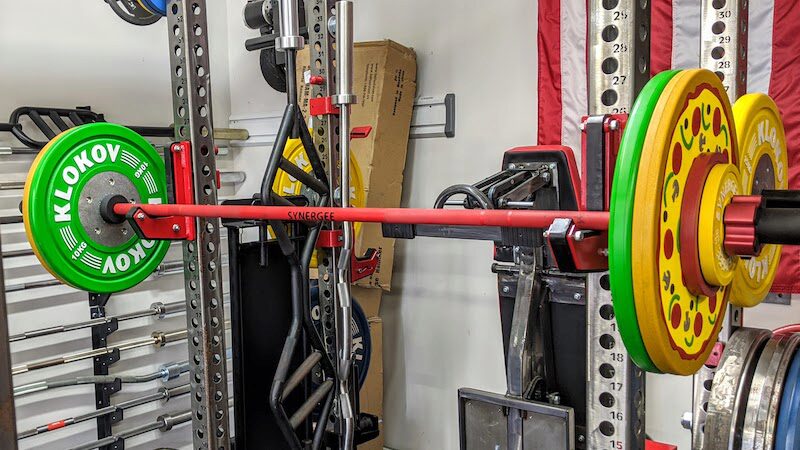 Synergee Games Barbell sitting on a power rack