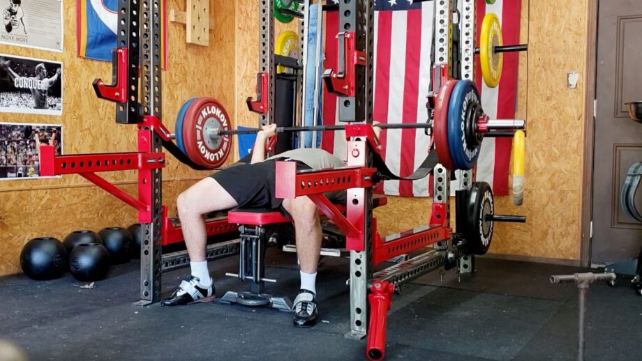 Person bench pressing in a garage gym