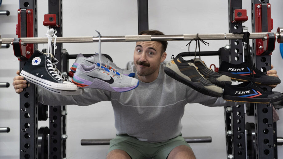 Coop smiles behind a barbell with the best cross-training shoes hanging from it