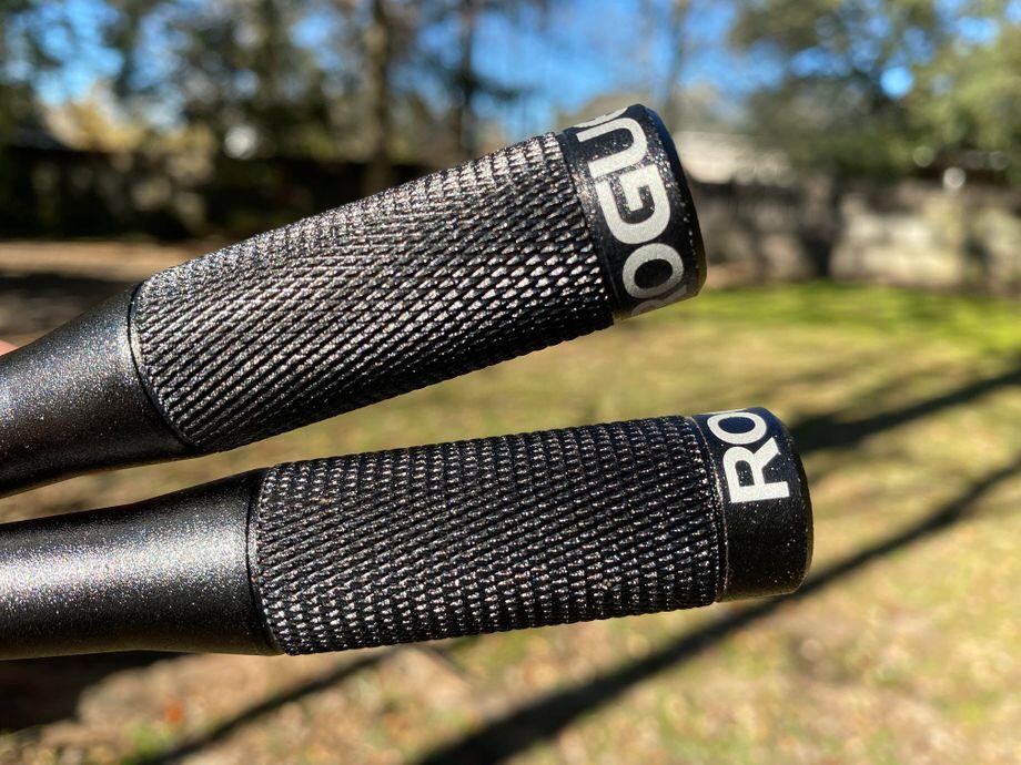 Close-up of the Rogue Fitness SR-2 3.0 Jump Rope handles, emphasizing the black precision-machined aluminum handles with tapered grips.