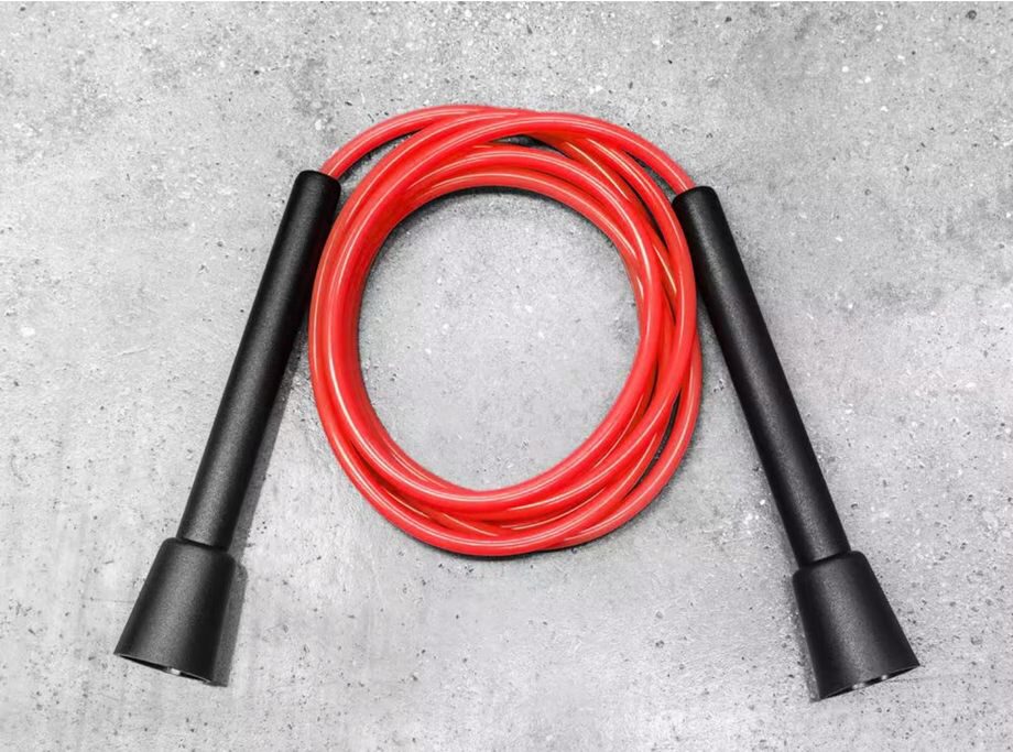 Close-up of the red Rogue Fitness Licorice Rope with simple black plastic handles and no bearings system.