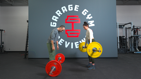 A man and a woman facing each other performing deadlifts with barbells