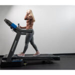 Woman walking on the Horizon 7.0 AT treadmill