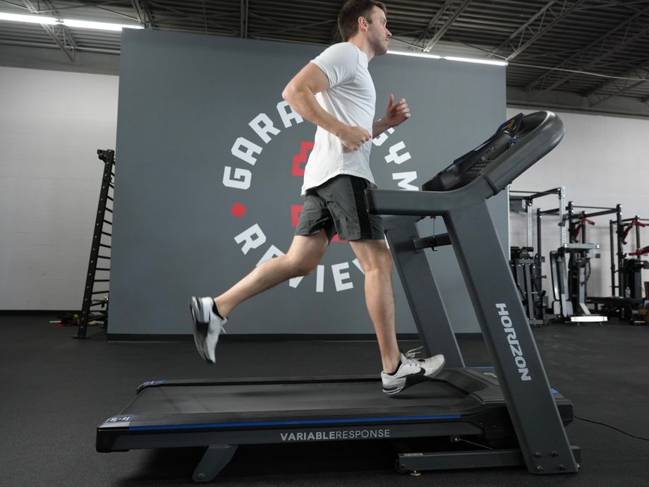 how much does a treadmill cost. man running on Horizon 7.4 Studio Treadmill