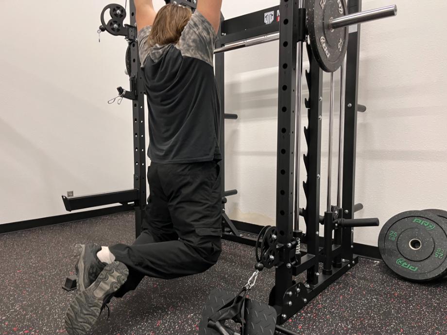 Profile view of Coop using cables on a Titan Fitness Functional Trainer