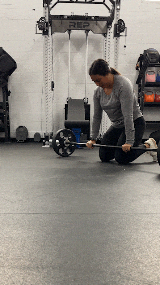 woman doing barbell ab rollouts
