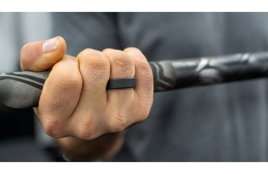 A close look at the Oura Ring on Coop's hand while he's holding a barbell