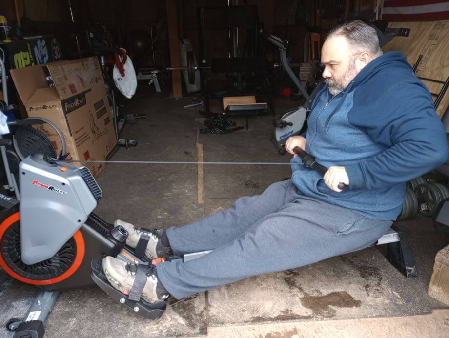 man using fitness reality rower