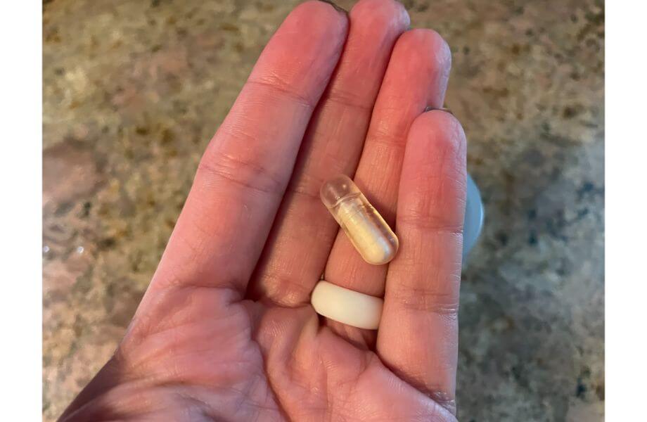 Our tester holding a single serving of probiotic capsules