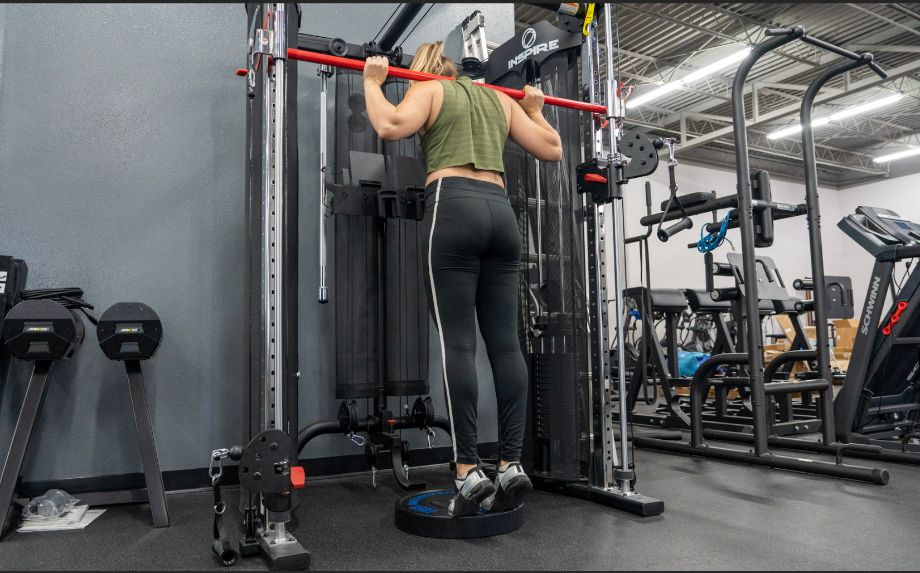 woman doing a calf exercise on a machine