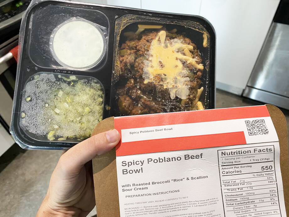 Person holding a Spicy Poblano Ground Beef meal from Factor Meals