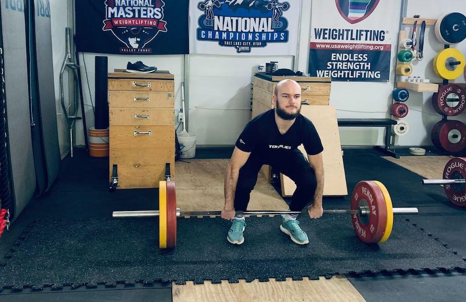 Man lifting on Living.Fit Gym Mats