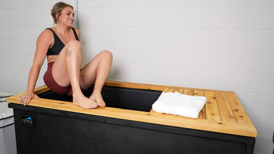 How to cold plunge: Woman getting in the Renu Therapy Cold Stoic tub
