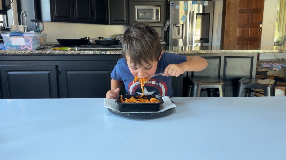 A boy eating a meal from Nurture Life