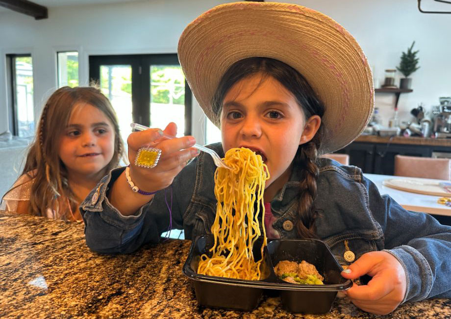 Girl eating spaghetti from Nurture Life