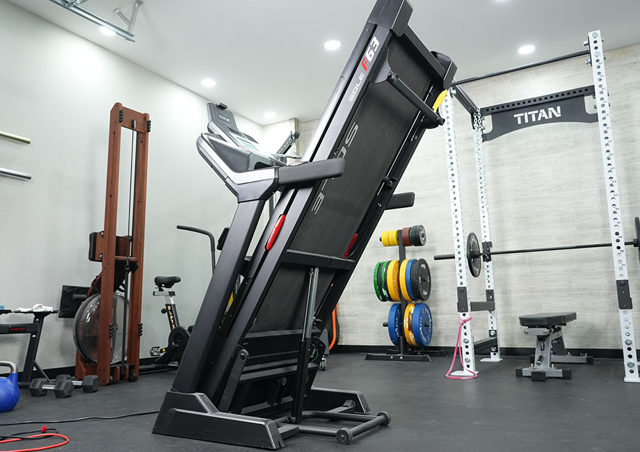 The Sole F63 Treadmill in a home gym, folded