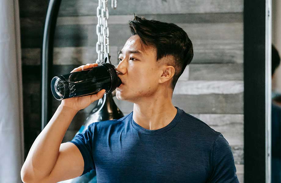 Teen drinking protein powder.