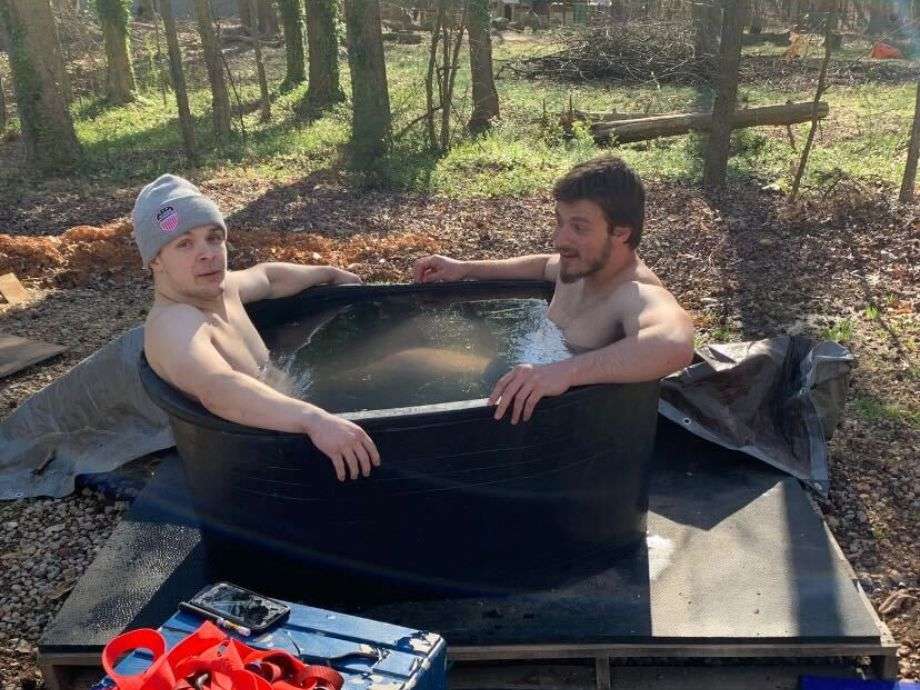 Two guys sitting in a Tuff Stuff Stock Tank