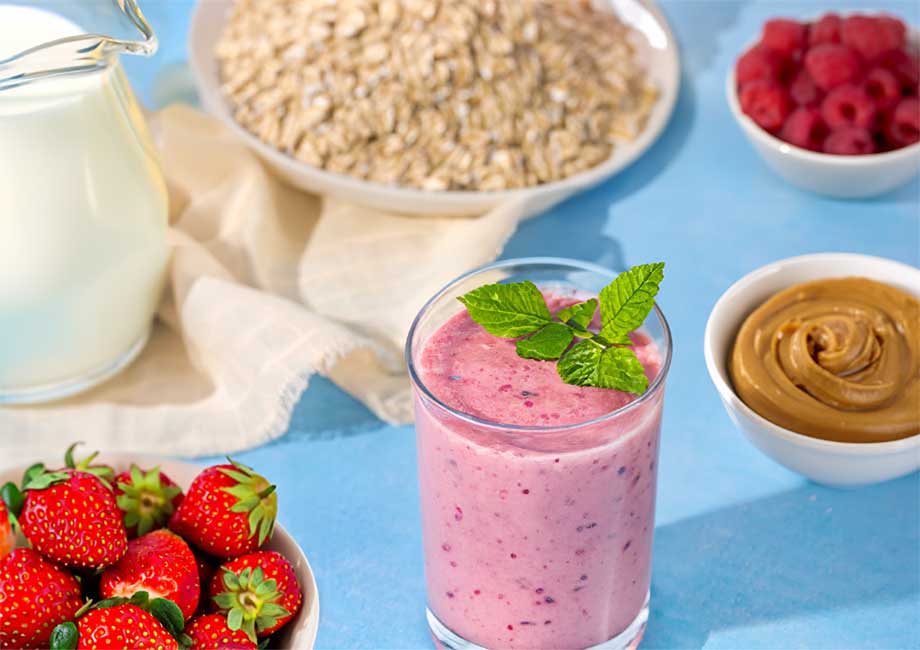 A smoothie surrounded by ingredients to make it
