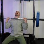 Coop doing an overhead press on the RitFit Smith Machine.