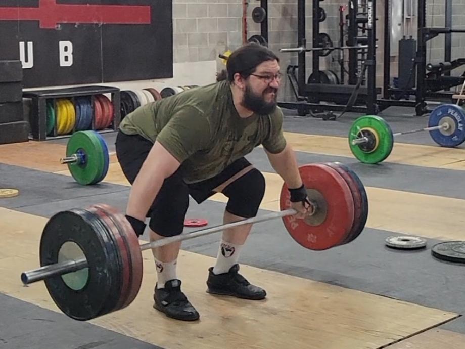 Man beginning a snatch grip deadlift