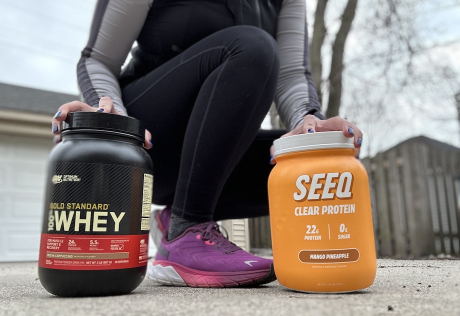 Woman holding a tub of Seeq and Optimum Nutrition protein powder