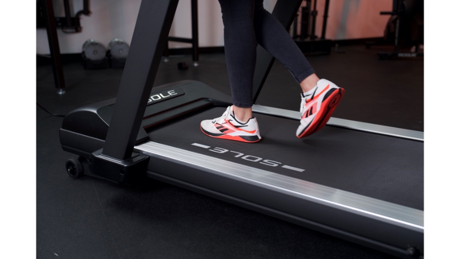 woman's feet running on sole fitness tt8 treadmill