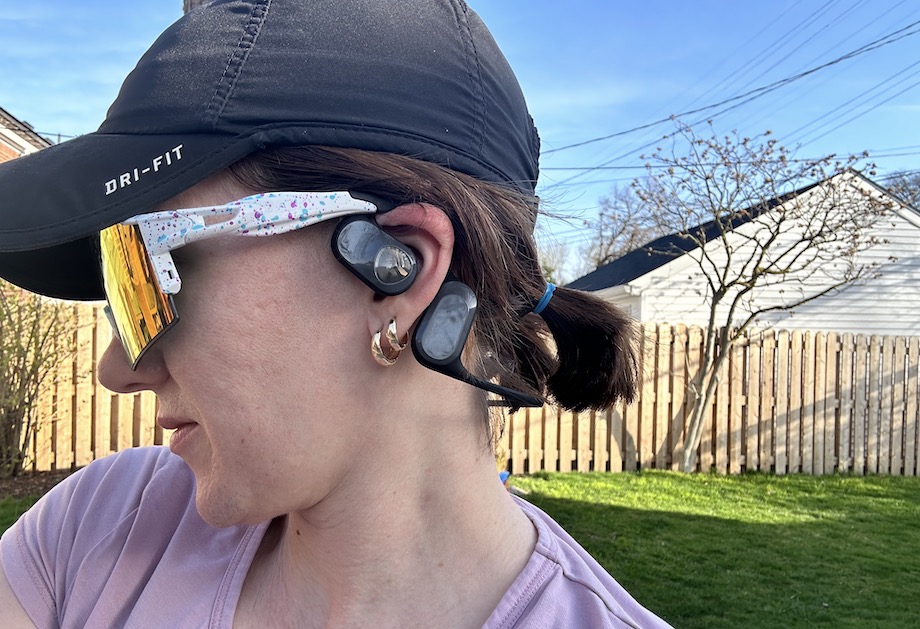 A woman wearing Soundpeats RunFree air conduction headphones