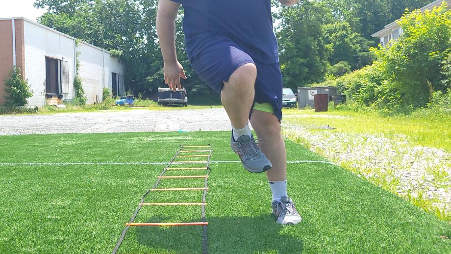 Man performing agility drills wearing the Fabletics Fundamental Short II