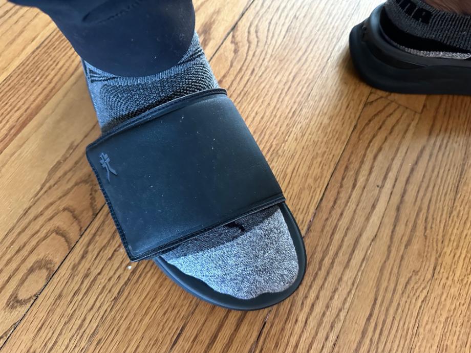 Man wearing Kuru Moment slide with socks