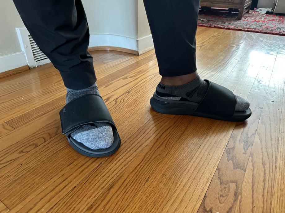 Man wearing Kuru Moment slide with socks