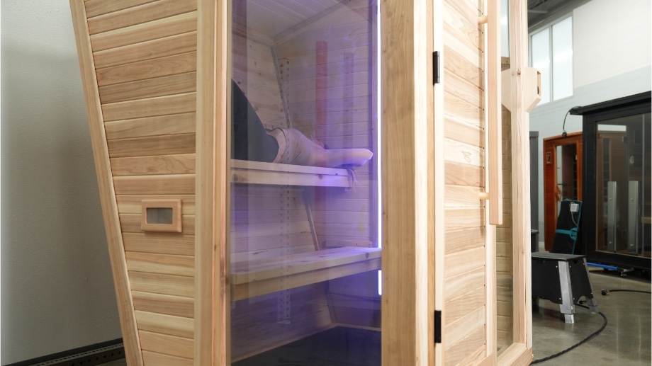 Looking through the window of the Plunge Sauna at our tester on the inside.