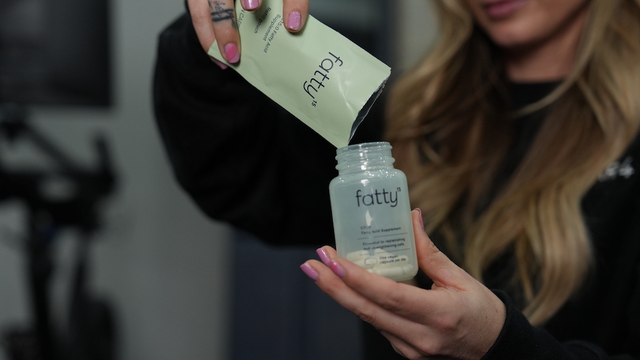 An image of a woman filling a Fatty15 bottle