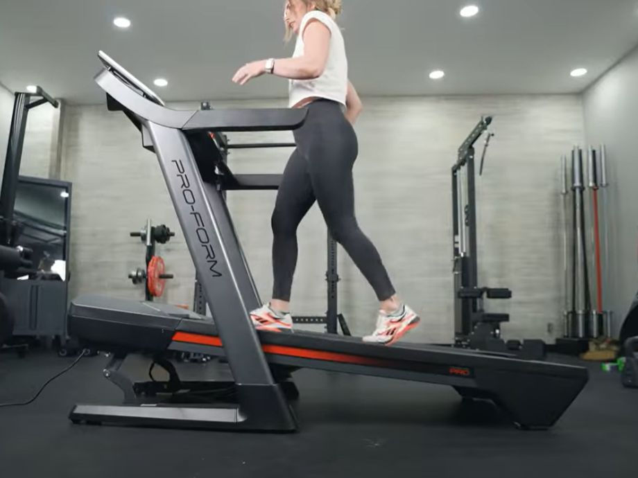 A woman walking on the ProForm Pro 2000 treadmill on an incline