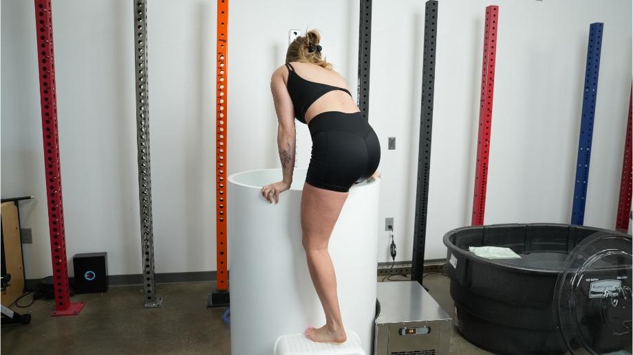 A woman climbs in to The Cold Life Plunge.